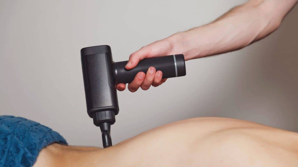 how to use massage gun on lower back