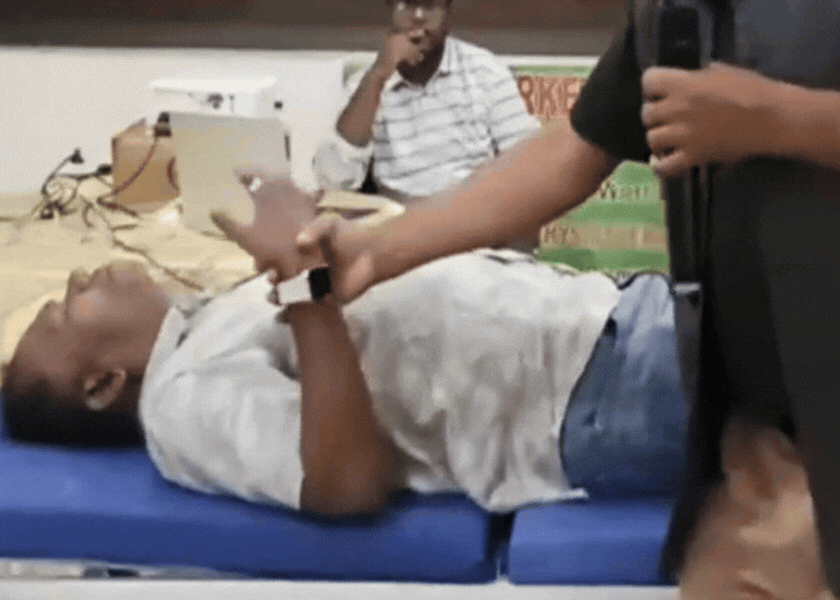 Physiotherapist performing quick stretch test on stroke patient's elbow showing spastic catch during rapid movement for spasticity assessment